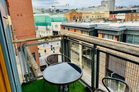 Charming balcony overlooking an urban street wi...
