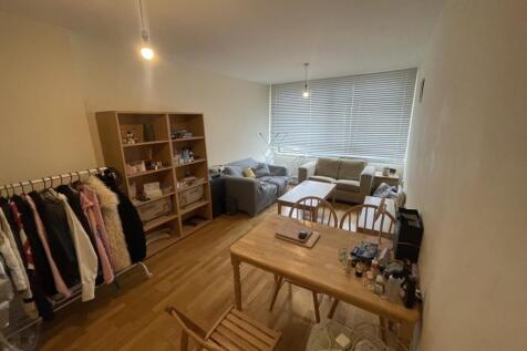 A cozy living room featuring wooden flooring an...