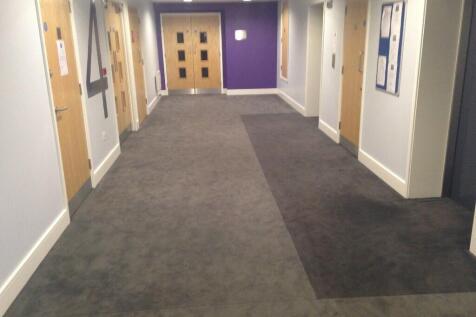 A clean and well-maintained hallway with neutra...
