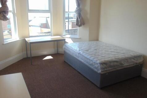 Bright single bedroom featuring a large bay win...