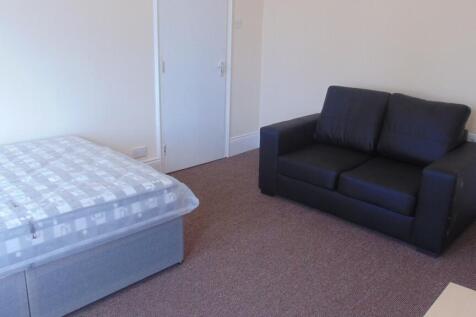A simple and tidy double bedroom featuring a co...