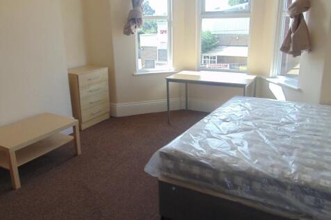 Bright double bedroom featuring a large bay win...