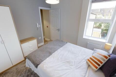 Bright and cozy double bedroom featuring a comf...