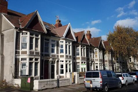 A charming row of terraced houses under a brigh...