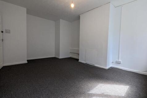 A clean, empty room with fresh white walls and ...