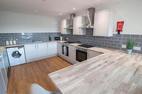 Bright and modern kitchen featuring spacious wo...