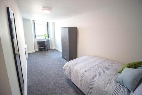A bright and tidy single bedroom featuring a co...