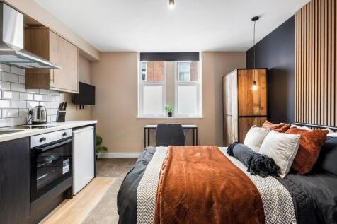 A stylish double bedroom featuring a comfortabl...