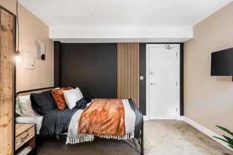 A stylish and cozy double bedroom featuring a c...