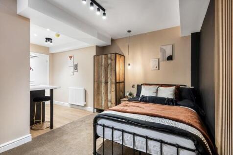 A stylish and cozy double bedroom featuring a c...