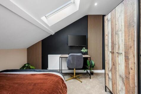 A stylish double bedroom featuring a modern slo...