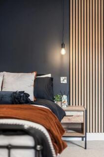 A modern double bedroom featuring a cozy bed dr...