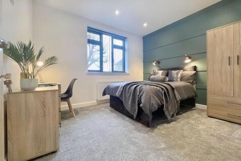 A stylish and well-maintained master bedroom fe...