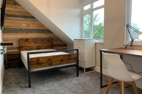 This charming double bedroom features stylish w...