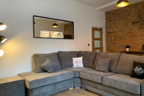 A stylish living room featuring a spacious sect...