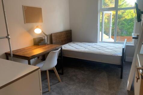 This inviting double bedroom features a comfort...