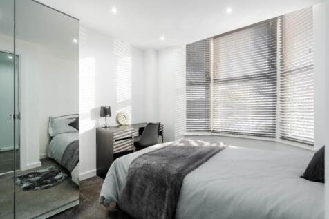 This inviting double bedroom features large win...