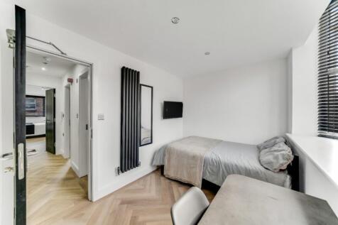 A bright and spacious double bedroom featuring ...