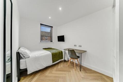 This inviting double bedroom features a cozy la...