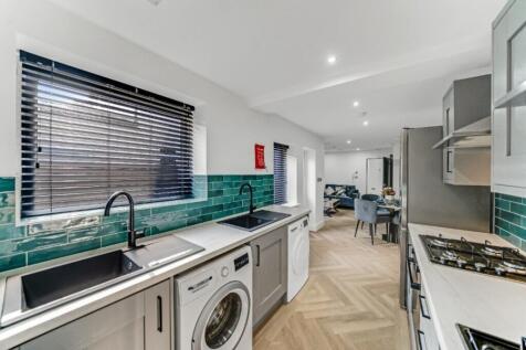 Modern kitchen featuring sleek appliances, ampl...