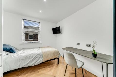 A modern double bedroom featuring a comfortable...