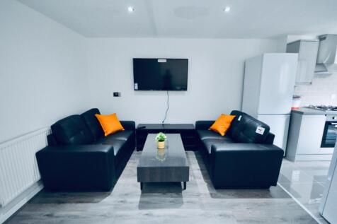 Spacious and modern living room featuring comfo...