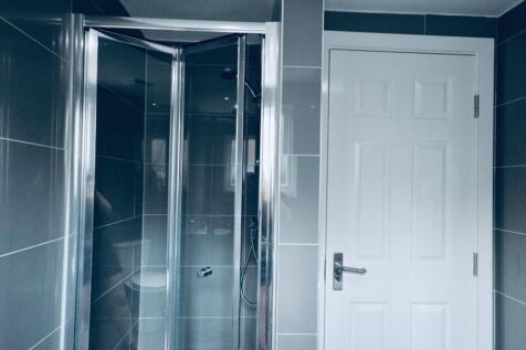 A modern bathroom featuring a sleek shower encl...