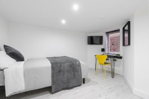 This stylish double bedroom features a comforta...