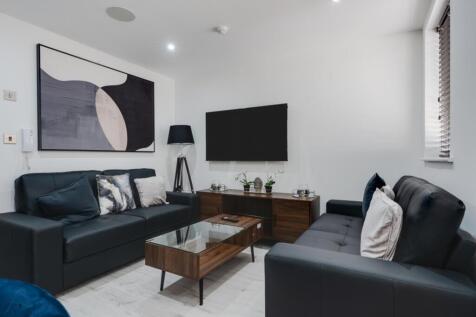 A stylish and contemporary living room featurin...