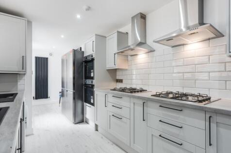 Modern kitchen featuring sleek cabinetry, high-...