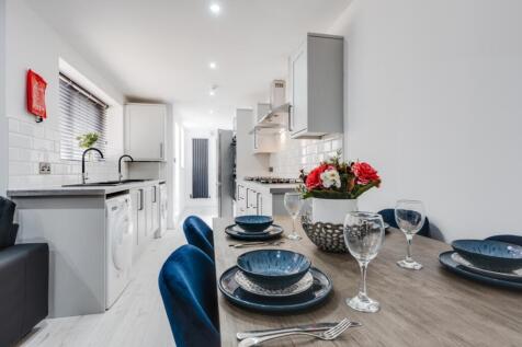 A modern kitchen featuring sleek cabinetry, a s...