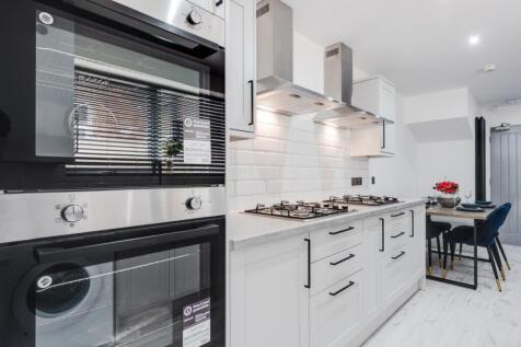 Modern kitchen featuring sleek cabinetry and hi...