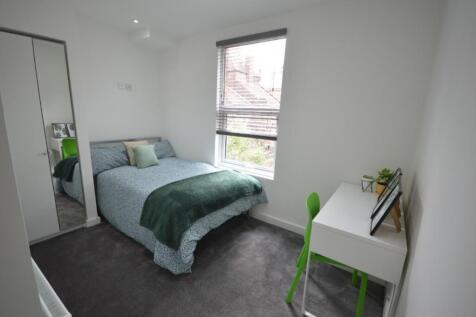 A bright and inviting double bedroom with moder...