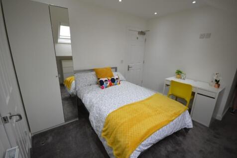 A bright and inviting double bedroom featuring ...