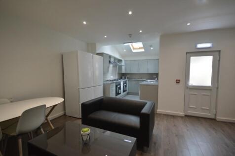 A modern and clean kitchenette with ample stora...