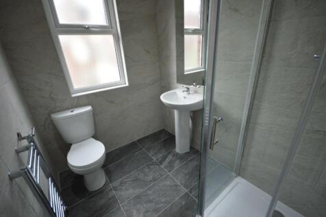 A modern bathroom featuring a stylish shower an...