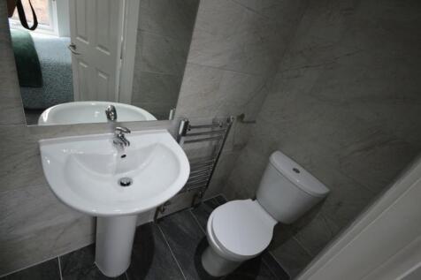 A modern and tidy bathroom featuring contempora...