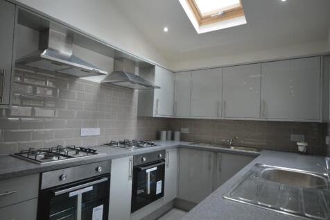 A modern and well-equipped kitchen featuring sl...
