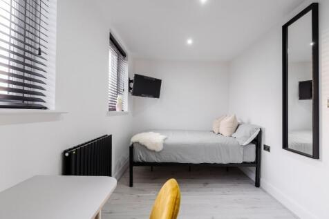This stylish double bedroom features a comforta...