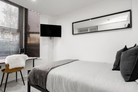 This stylish double bedroom offers a cozy retre...