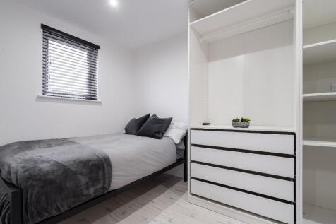 This cozy double bedroom features a comfortable...