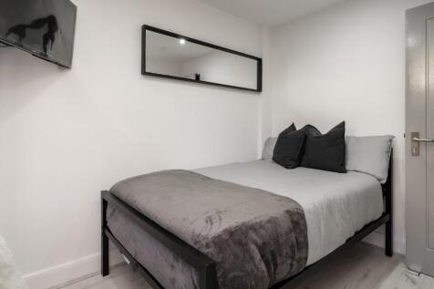 Cozy double bedroom featuring a comfortable bed...