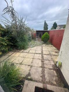 A private garden featuring a paved patio area w...