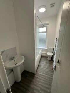 Bright and clean bathroom featuring a modern ba...