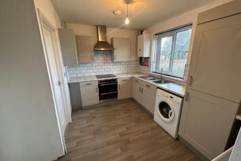 Bright and modern kitchen featuring ample cabin...