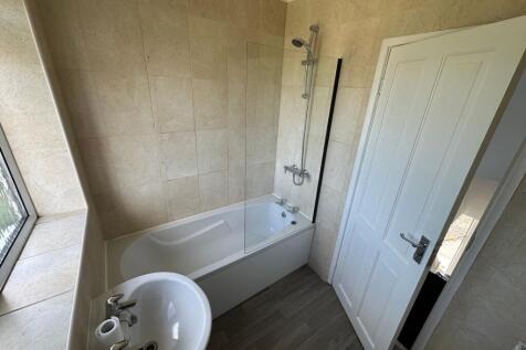 Bright and modern bathroom featuring a clean wh...