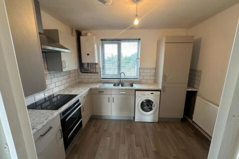 A clean and modern kitchen featuring ample coun...