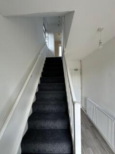 A clean and well-maintained staircase with dark...