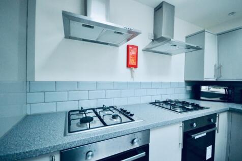 Modern kitchen featuring sleek countertops and ...
