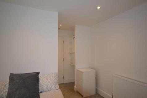 This inviting double bedroom features a cozy at...